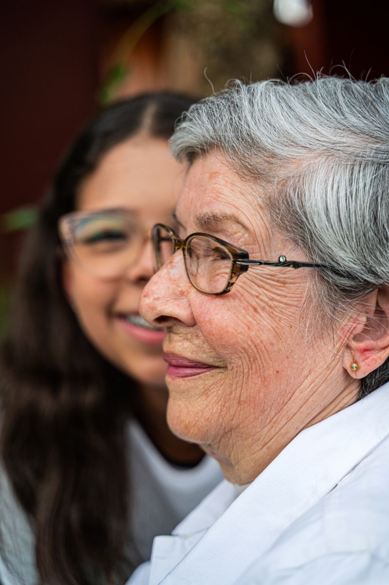An older woman and her granddaughter sharing a warm moment together at home