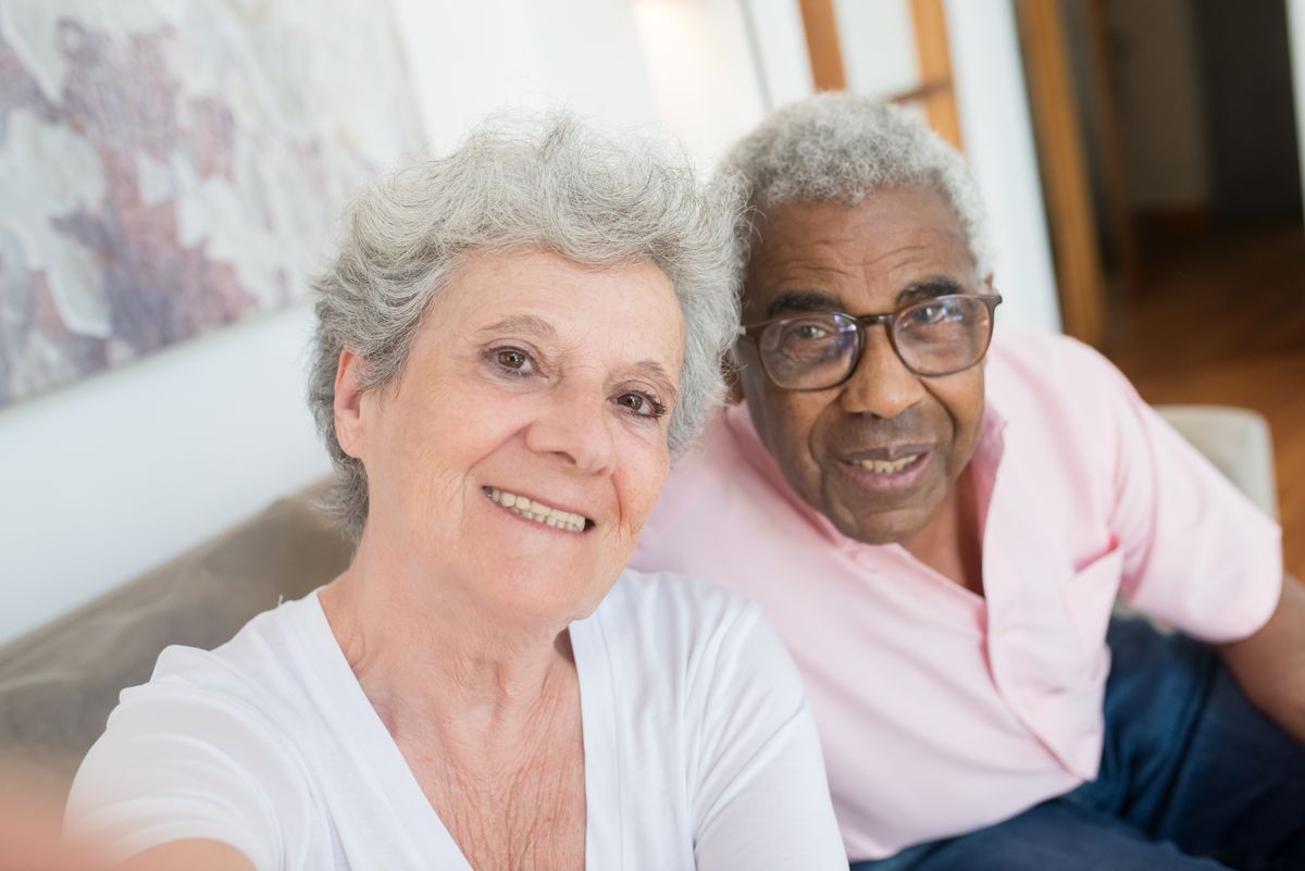 Happy elderly couple enjoying time together at home